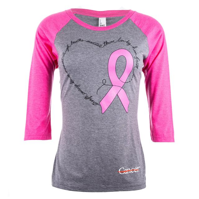 Gray raglan tee with pink quarter length sleeves featuring a pink ribbon for breast cancer awareness month and a heart. Also featuring the white cancer strikethrough logo at the bottom hem.