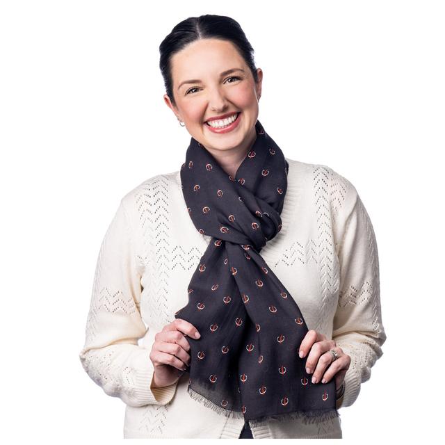 MD Anderson employee wearing the black scarf featuring the white strikethrough "C" pattern.