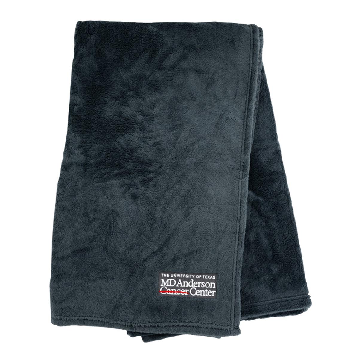 Black soft touch throw featuring the white MD Anderson logo on the corner.